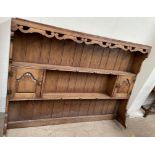 An oak dresser rack, with two shelves and two cupboards,