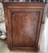 An 18th century oak hanging corner cupboard,