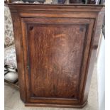 An 18th century oak hanging corner cupboard,