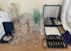 A glass decanter together with a cut glass claret jug, drinking glasses,