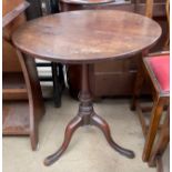 A 19th century mahogany tripod table with a circular top on a baluster column and three legs