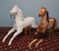 Two Victorian carousel horses, one restored, the other in original condition,
