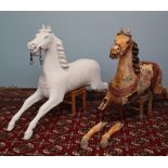 Two Victorian carousel horses, one restored, the other in original condition,