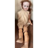 An Armand Marseille bisque head doll, with blue closing eyes, open mouth and teeth,