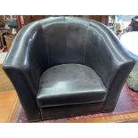 A brown leather tub chair