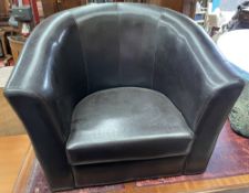 A brown leather tub chair