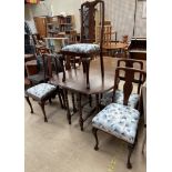 A 20th century oak drop leaf dining table together with a matched set of five Queen Anne style