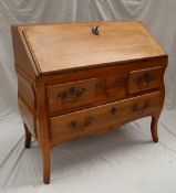 A French provincial Louis XVI walnut bombe bureau,