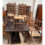 An early 20th century oak extending dining table together with a set of five ladder back dining