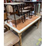 A modern tiled top dining table, on turned legs together with a bamboo occasional table,