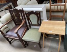 A carved oak elbow chair together with two other chairs,