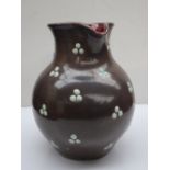 D Hallance - A studio pottery jug, with a mottled grey ground applied with green beads,