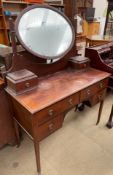 An Edwardian mahogany dressing table, with an oval mirror and two drawers,