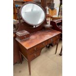 An Edwardian mahogany dressing table, with an oval mirror and two drawers,