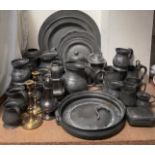 A collection of pewter chargers, pewter tankards, pewter jug,