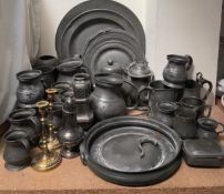 A collection of pewter chargers, pewter tankards, pewter jug,