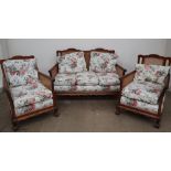 An early 20th century bergere suite, comprising a tow seater settee and two arm chairs,