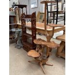 A glass top wine table with an elephant head base together with a mahogany shelf unit and a