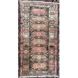 A pink ground rug, with eight geometric medallions and multiple guard stripes,