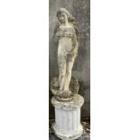A reconstituted stone figure of a maiden emerging from a shell, on a plinth,