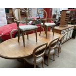 A modern pine extending dining table together with eight balloon back dining chairs a sideboard and