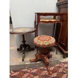 A Victorian walnut piano stool, the circular woolwork top on a reeded column and tripod base,