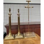 A pair of brass table lamps together with a brass fireside stand