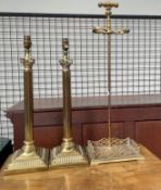 A pair of brass table lamps together with a brass fireside stand