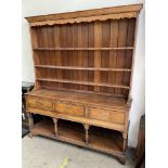 An 18th century South Wales oak dresser, the moulded cornice above three shelves,