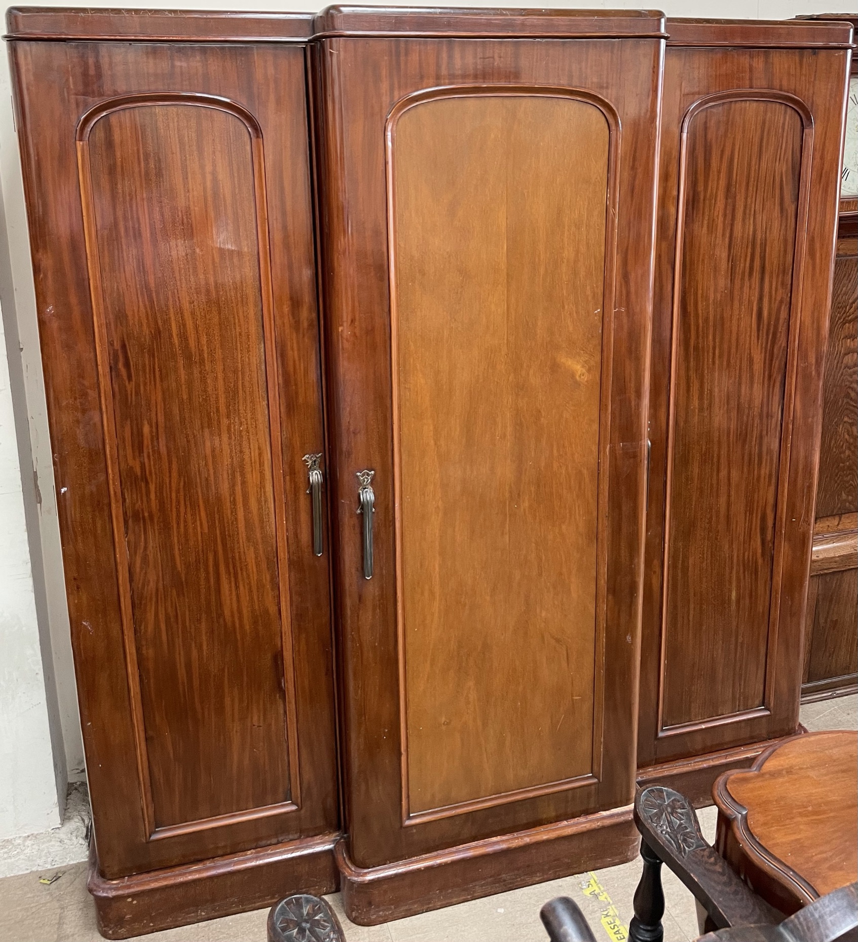 A Victorian mahogany triple wardrobe, with a moulded cornice above three doors on a plinth,