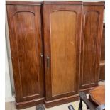 A Victorian mahogany triple wardrobe, with a moulded cornice above three doors on a plinth,