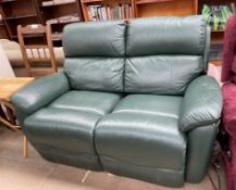 A Green leather two seater Timotion electric settee (Sold as seen,
