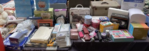 A collection of new / used and boxed products including umbrellas, throw, purses, picture frames,
