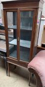An Edwardian mahogany display cabinet with a pair of glazed doors and glazed sides on square