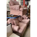 A pink and cream upholstered two piece suite comprising a three seater settee and an armchair