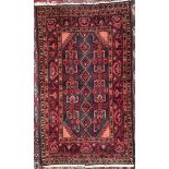 A blue ground rug, with geometric stylised flower heads and multiple guard stripes,