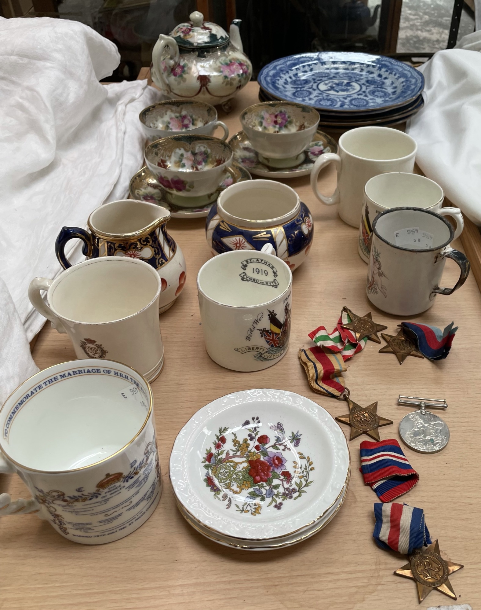 Five World War II medals, together with commemorative china,