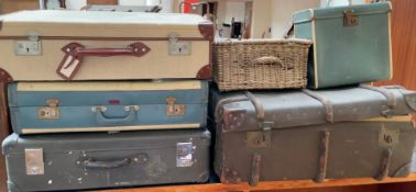 A banded trunk together with three suitcases,
