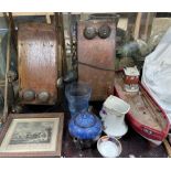 Two wooden wall mounted telephones together with a model ship,