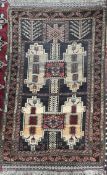 A small rug, with a brown ground, and geometric medallions,