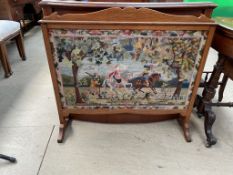 An oak framed fire screen with hunting scene woolwork panel