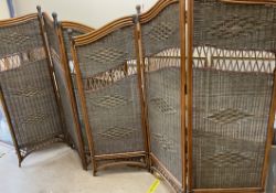 A pair of bamboo and wicker three fold screens