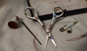 A continental white metal and enamel decorated sewing set, comprising scissors, thimble,