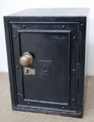 A black painted safe with a brass ball handle,