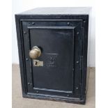 A black painted safe with a brass ball handle,