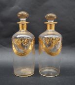 A pair of 19th gilt decorated glass decanters, decorated with flowers and leaves, 18.