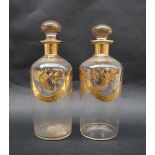 A pair of 19th gilt decorated glass decanters, decorated with flowers and leaves, 18.