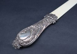An Edward VII silver handled and ivory folio page turner, decorated with scrolling leaves, London,