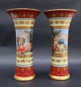 A pair of Vienna style flared vases, painted with maidens and cherubs,