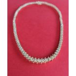 A 14ct yellow gold diamond set necklet set with one hundred and five round brilliant cut diamonds,